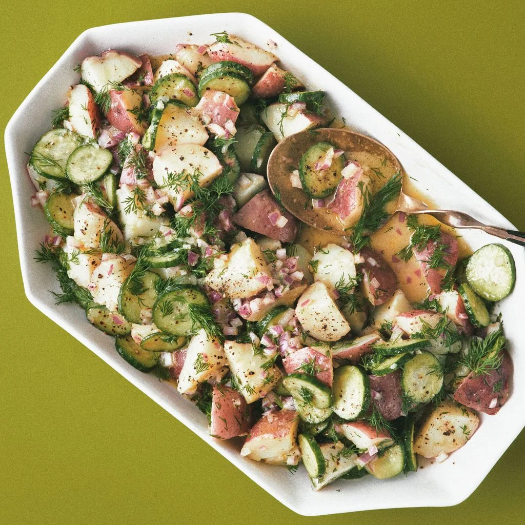 Quartered red potatoes sliced Persian cucumbers diced red onions and sprigs of dill tossed in a mustardy vinaigrette.