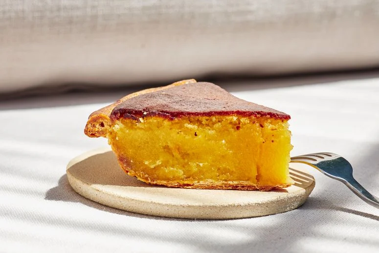 Slice of pie seen straight on with a fork on the side.