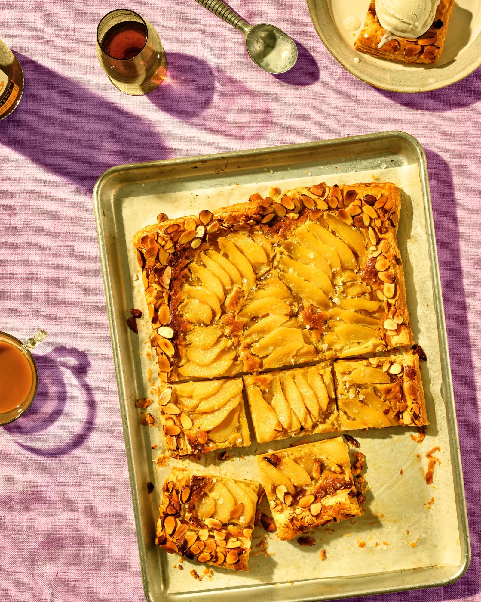 Pear galette with ice cream on lavender tablecloth.