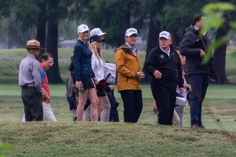United States Secretary of the Interior and Chair, National Energy Council and White House Energy Czar Doug Burgum, center left, and US President Donald J Trump at East Potomac Golf Links in Washington, DC, US