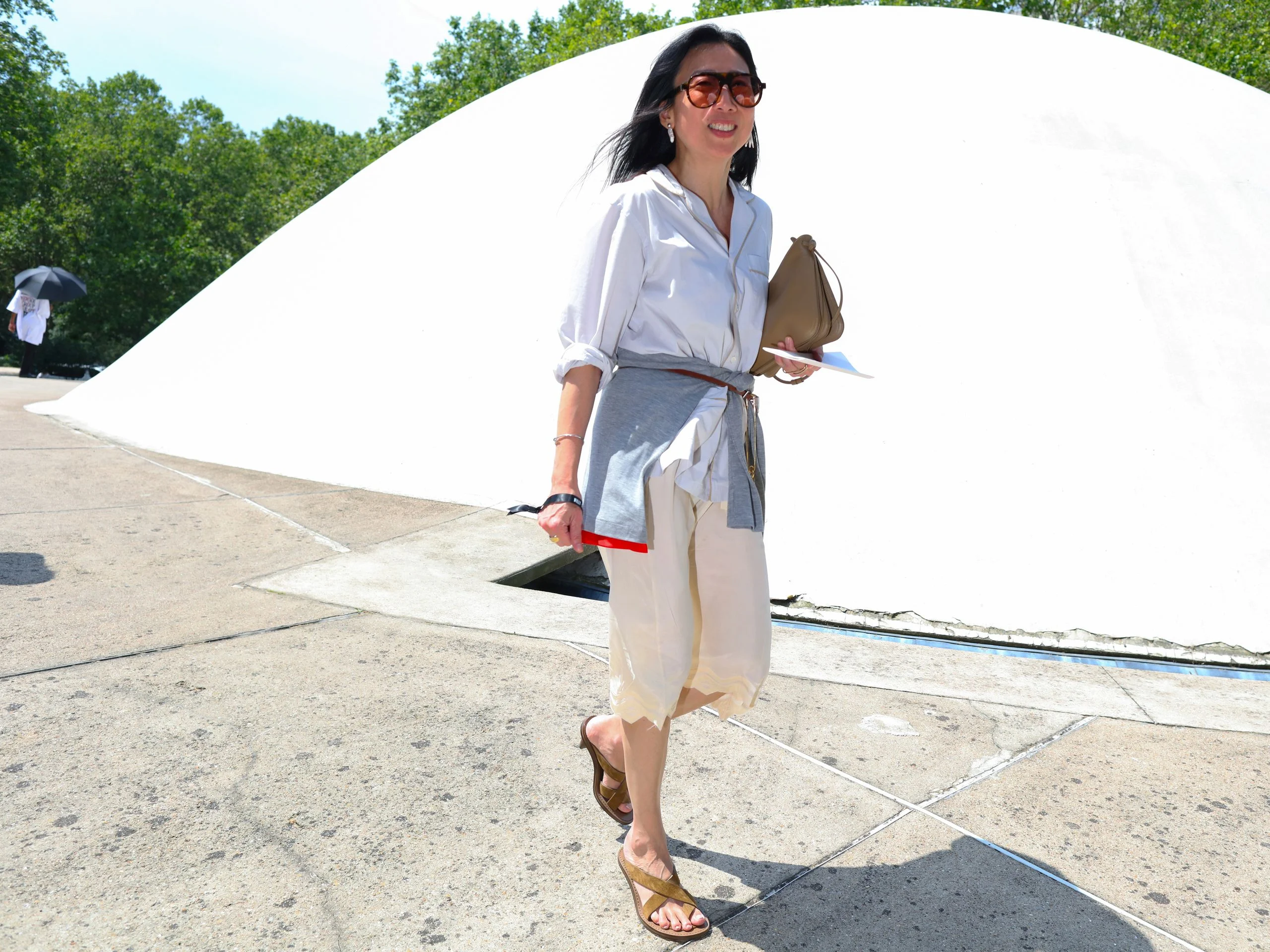 Image may contain Clothing Footwear Sandal Shoe Beachwear Shorts Sleeve Pants Person and High Heel