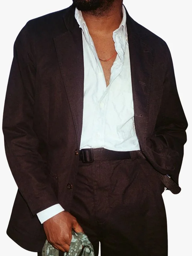 Image may contain Blazer Clothing Coat Jacket Formal Wear Suit and Accessories