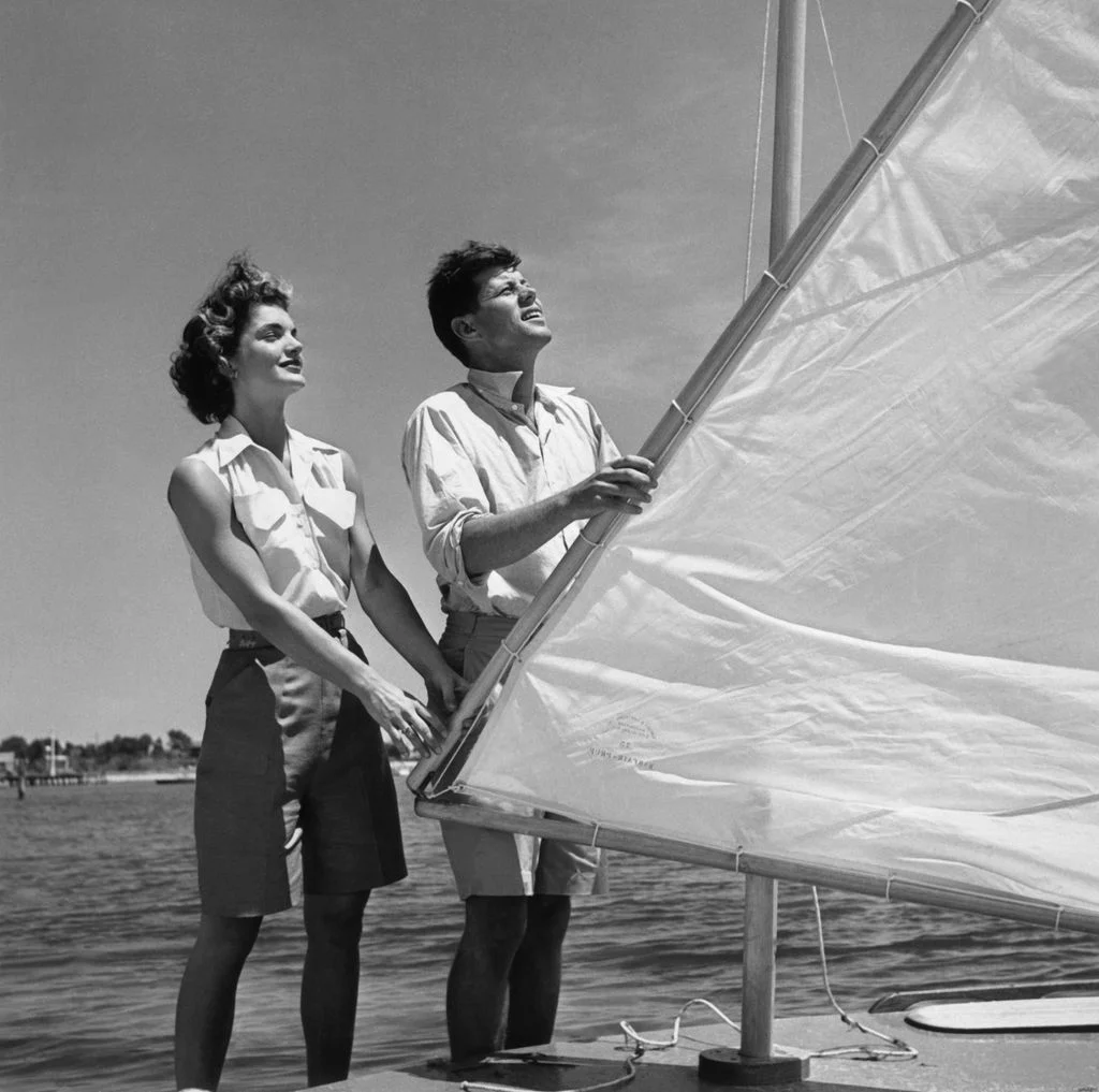 Image may contain John F. Kennedy Jacqueline Kennedy Onassis Boat Sailboat Transportation Vehicle Clothing and Shorts