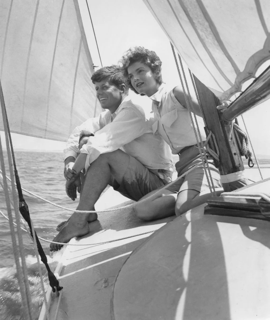 Image may contain Jacqueline Kennedy Onassis John F. Kennedy Boat Sailboat Transportation Vehicle Face and Head