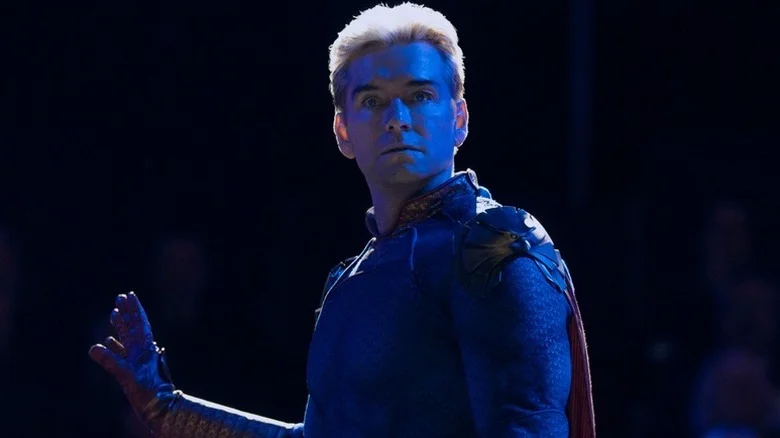 Homelander (Antony Starr) stands bathed in blue light in The Boys