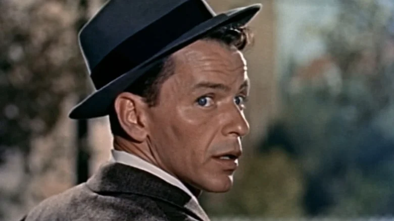 Frank Sinatra's Barney Sloan looks over his shoulder as he stands on a porch in Young at Heart