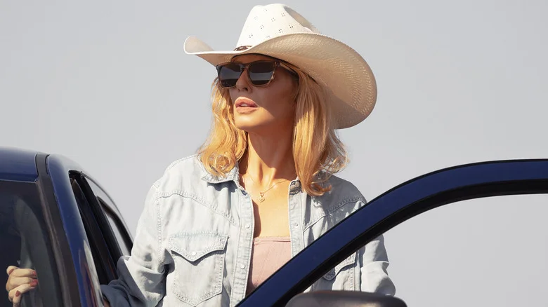 Kelly Reilly's Beth Dutton stands on the side of her truck looking off into the distance in Dutton Ranch