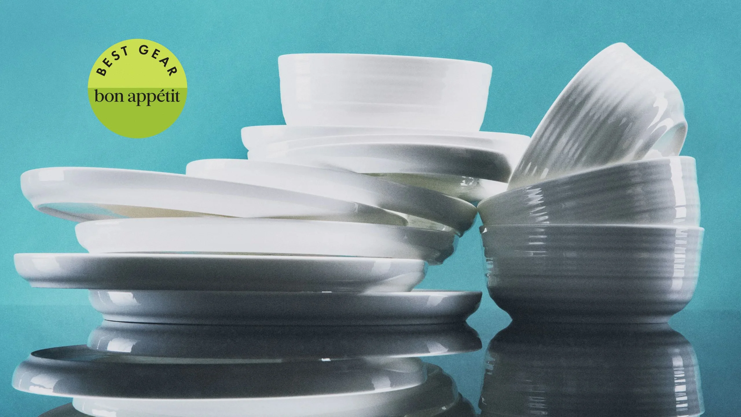 A stack of Mikasa Callie Bone China Lightweight Chip Resistant 12 Piece Dinnerware Set.