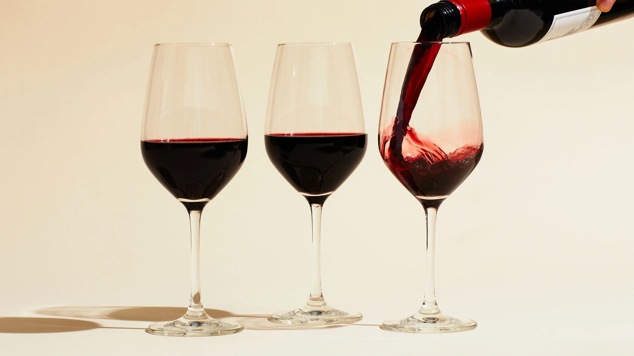 Three glasses of red wine.