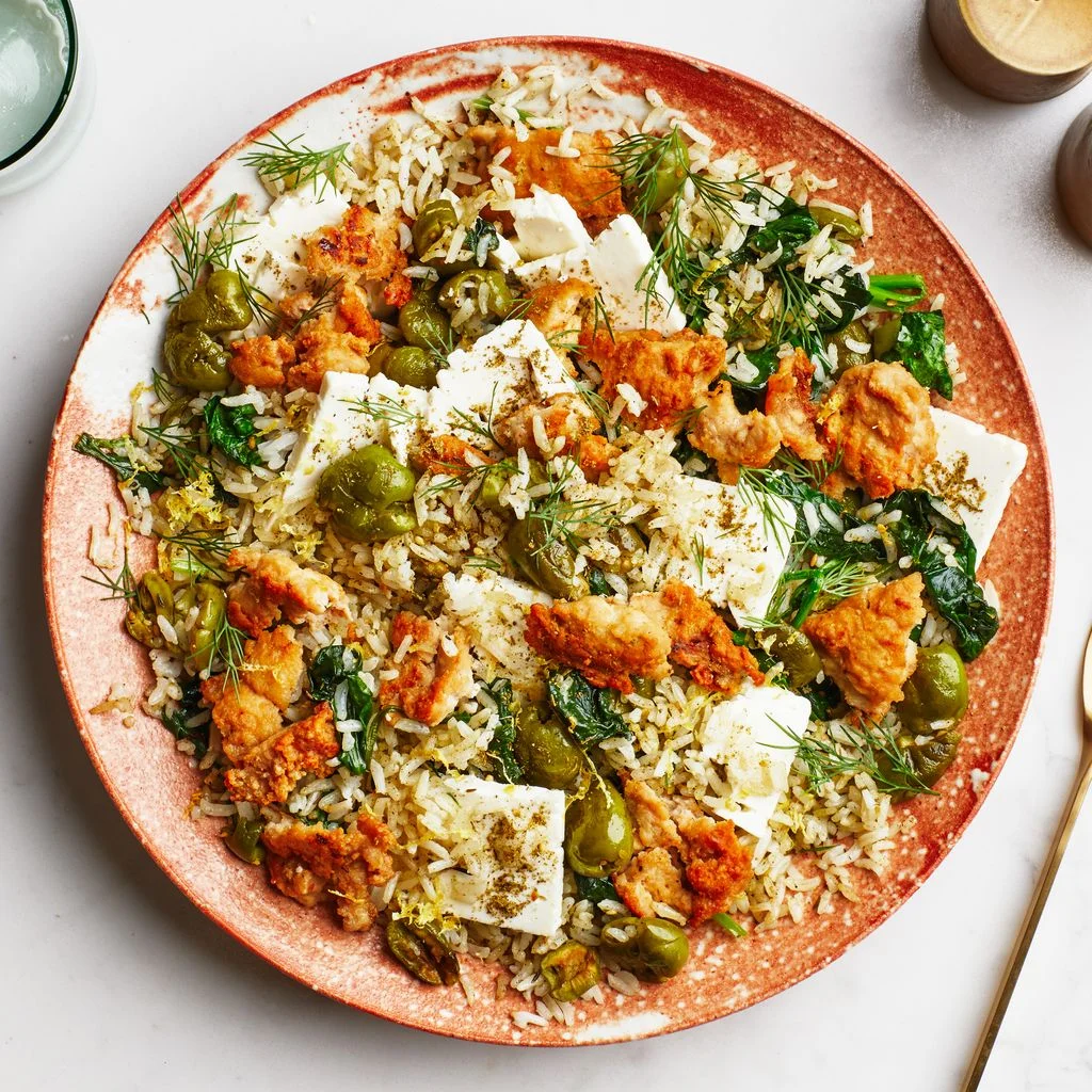 Crispy chicken with zaatarolive rice on a plate