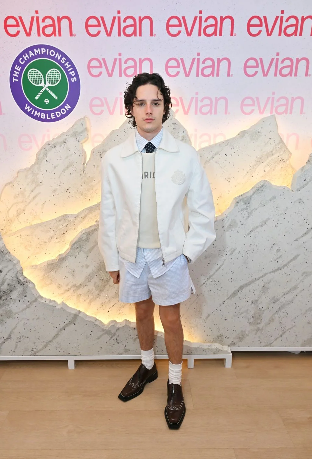 Image may contain Glenn Quinn Clothing Coat Shorts Lab Coat Shirt Blazer Jacket Person Teen Footwear and Shoe