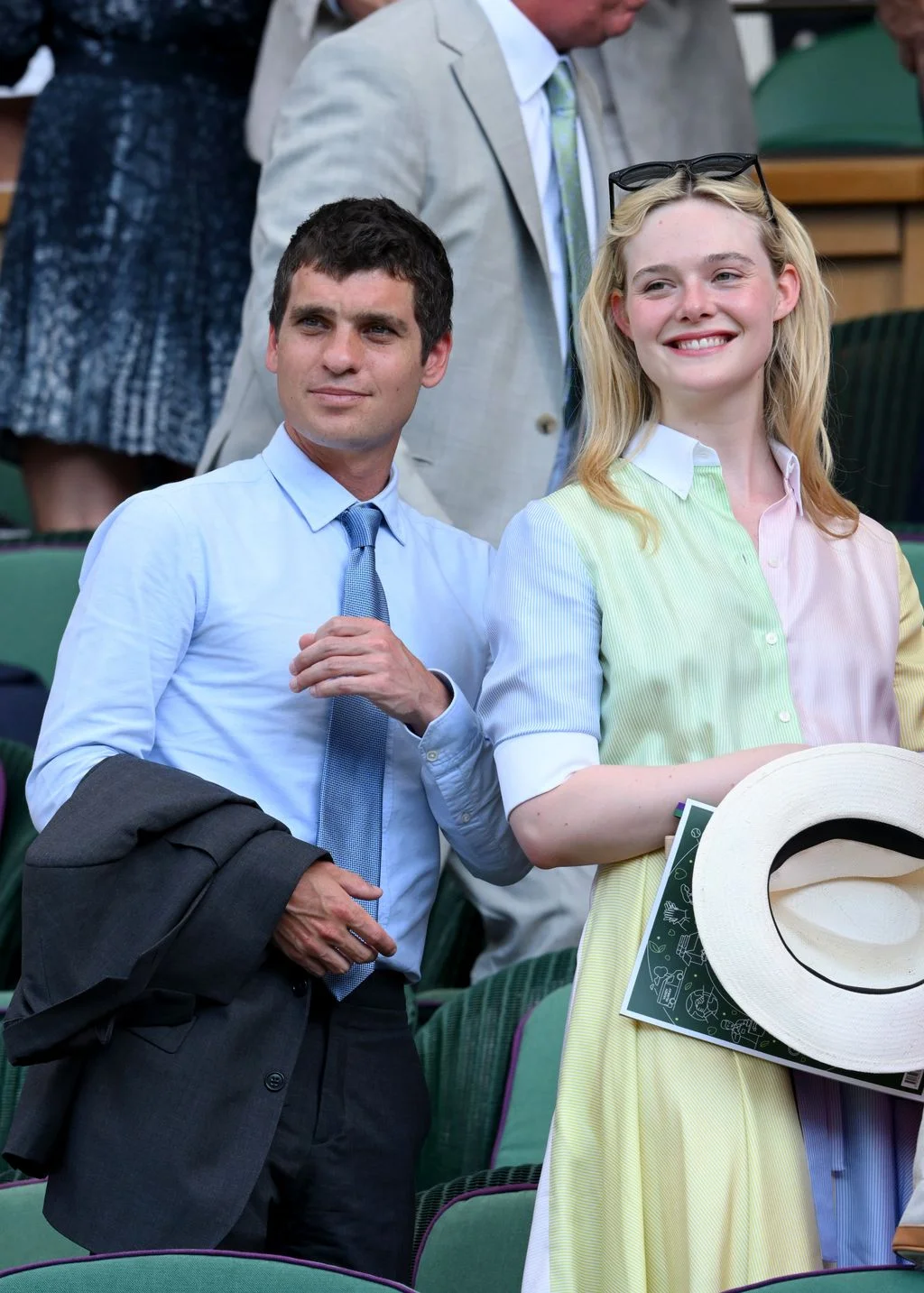 Image may contain Elle Fanning Accessories Formal Wear Tie Clothing Shirt Hat Suit Blazer Coat Jacket and People