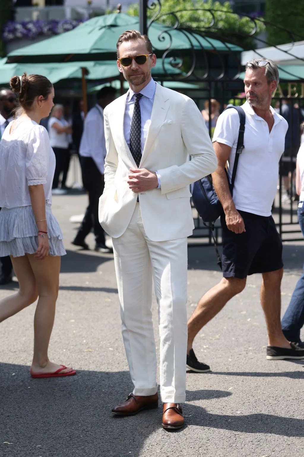 Image may contain Tom Hiddleston Grace Stewart Bill Kenney Clothing Formal Wear Suit Person Walking Blazer and Coat