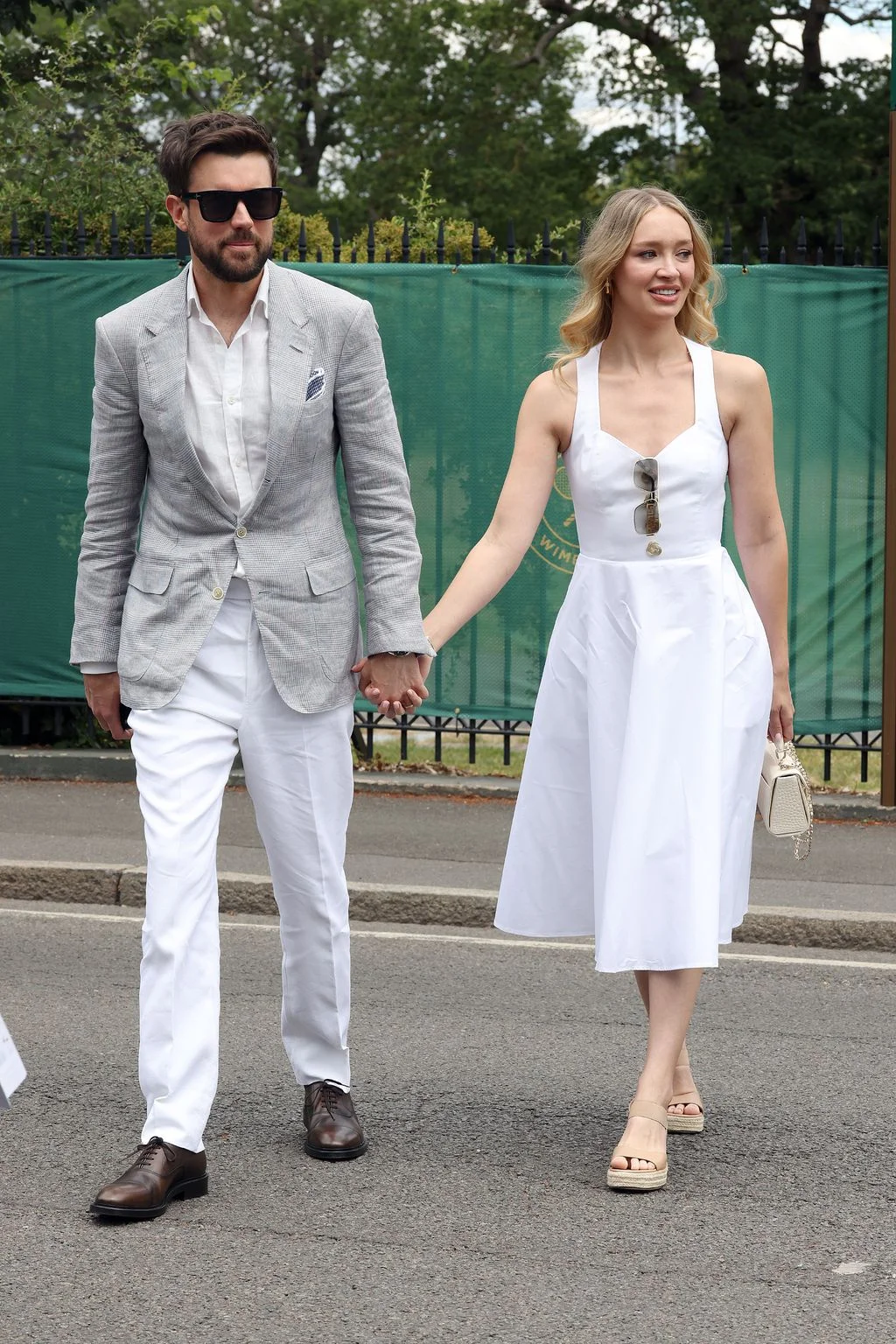 Image may contain Jack Whitehall Lauren Pope Body Part Hand Person Holding Hands Adult Formal Wear and Clothing