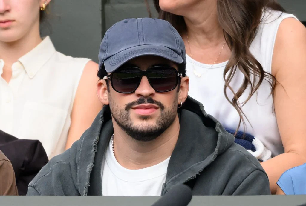 Image may contain Bad Bunny Accessories Sunglasses Baseball Cap Cap Clothing Hat Adult Person Head and Face