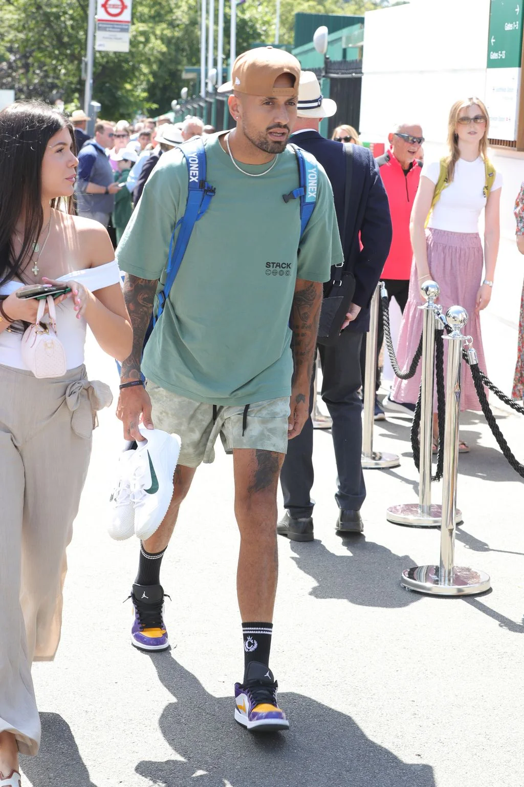 Image may contain Nick Kyrgios Clothing Shorts Person Teen Adult Footwear Shoe Accessories Jewelry and Necklace