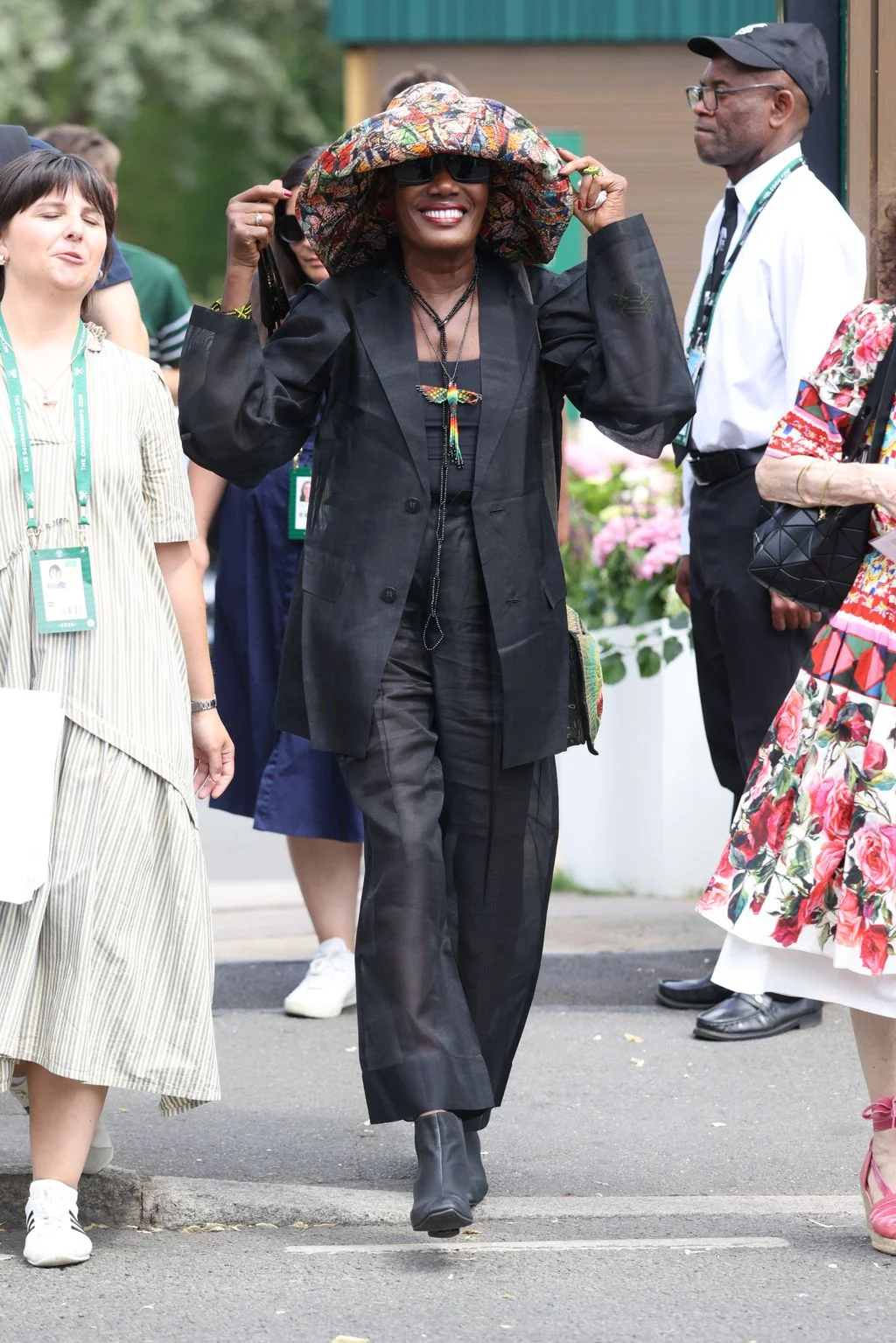 Image may contain Grace Jones L.A. Reid Person Adult Clothing Skirt Coat Face Head Accessories and Glasses