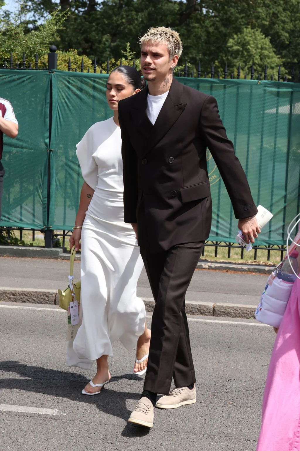 Image may contain Clothing Formal Wear Suit Blazer Coat Jacket Dress Tuxedo Adult Person Wedding and Walking
