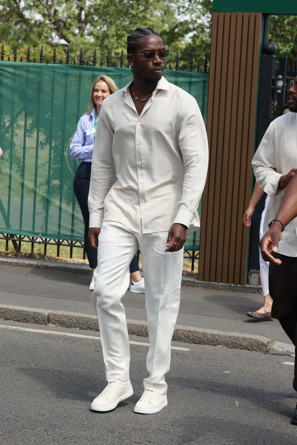 Image may contain Damson Idris Janine Turner Person Standing Pedestrian Adult Clothing Coat Footwear Shoe and Face
