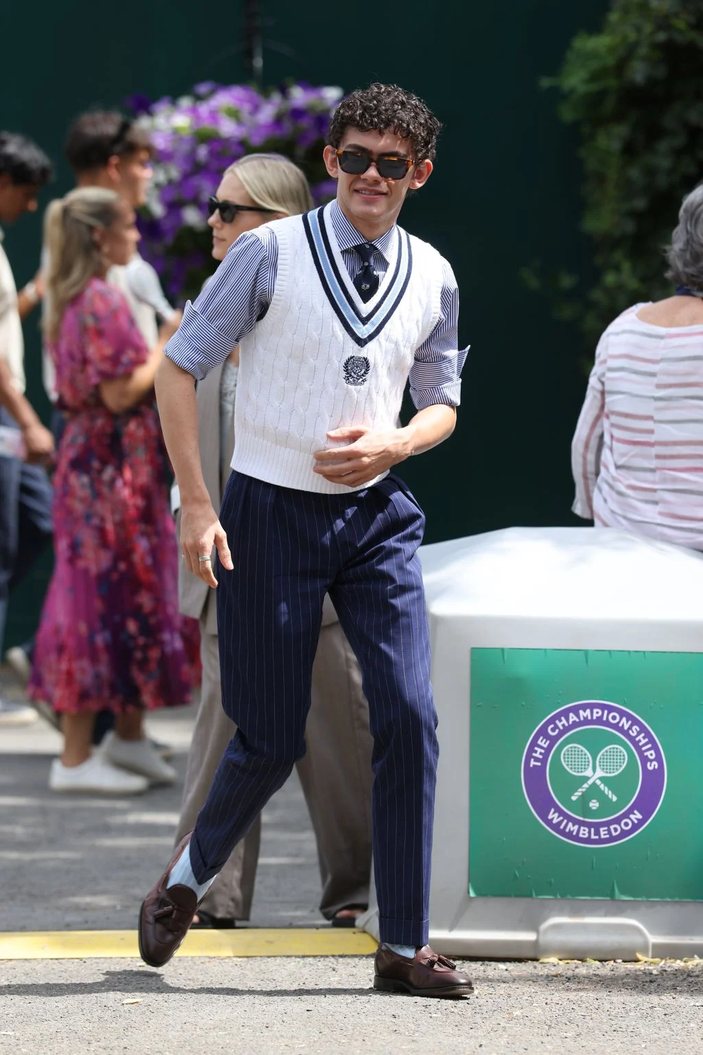 Image may contain Clothing Formal Wear Suit Adult Person People Footwear Shoe Walking and Pants