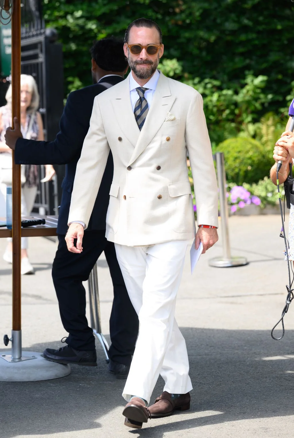 Image may contain Joseph Fiennes Clothing Formal Wear Suit Blazer Coat Jacket Person Walking Adult and Body Part