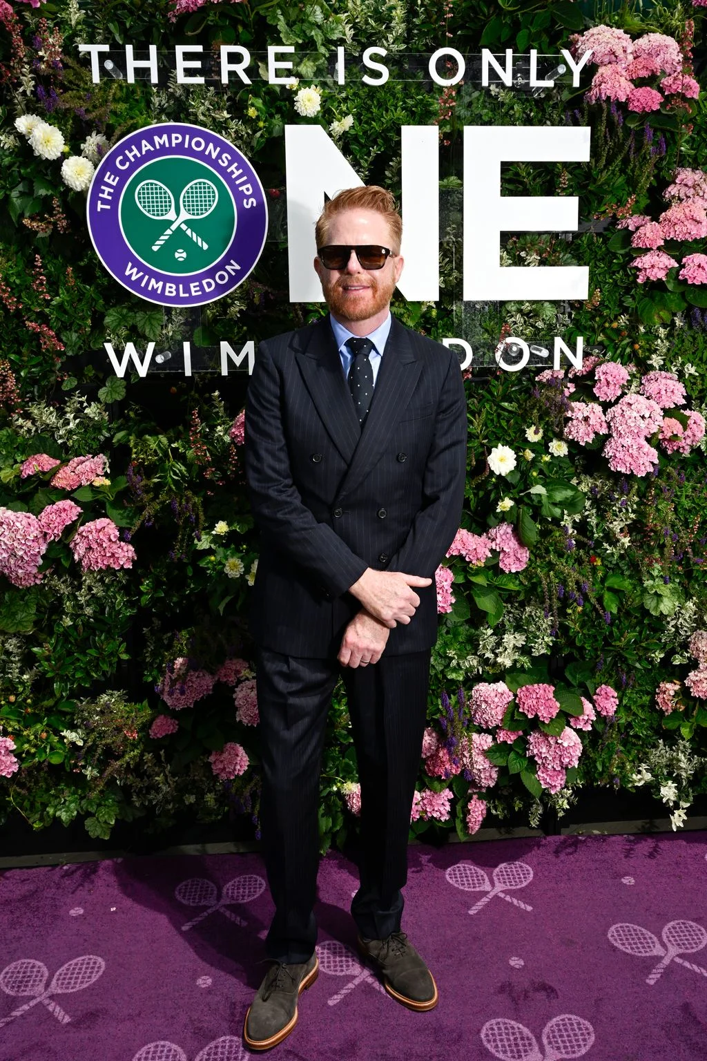 Image may contain Jesse Tyler Ferguson Purple Clothing Formal Wear Suit Face Head Person Photography and Portrait