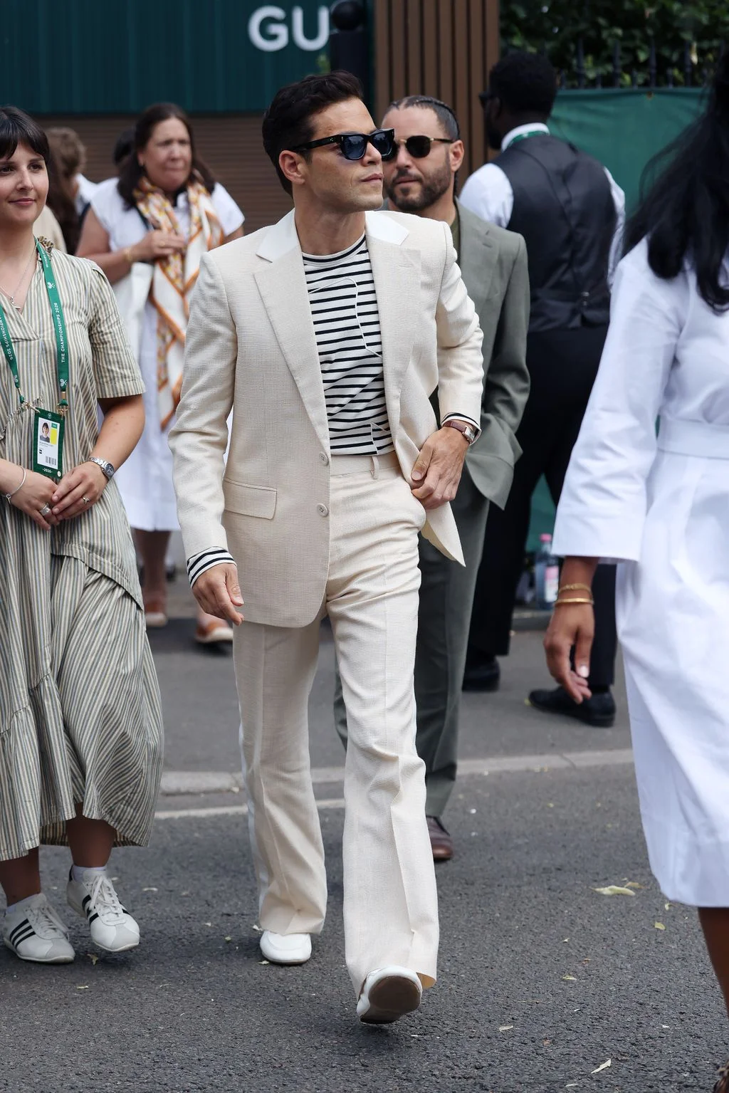 Image may contain Rami Malek Rami Malek Maryam Hassouni Adult Person Clothing Formal Wear Suit Blazer and Coat