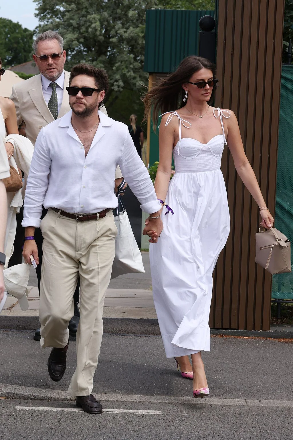 Image may contain Niall Horan Rebeca Minguela Body Part Hand Person Holding Hands Pedestrian Adult and Walking