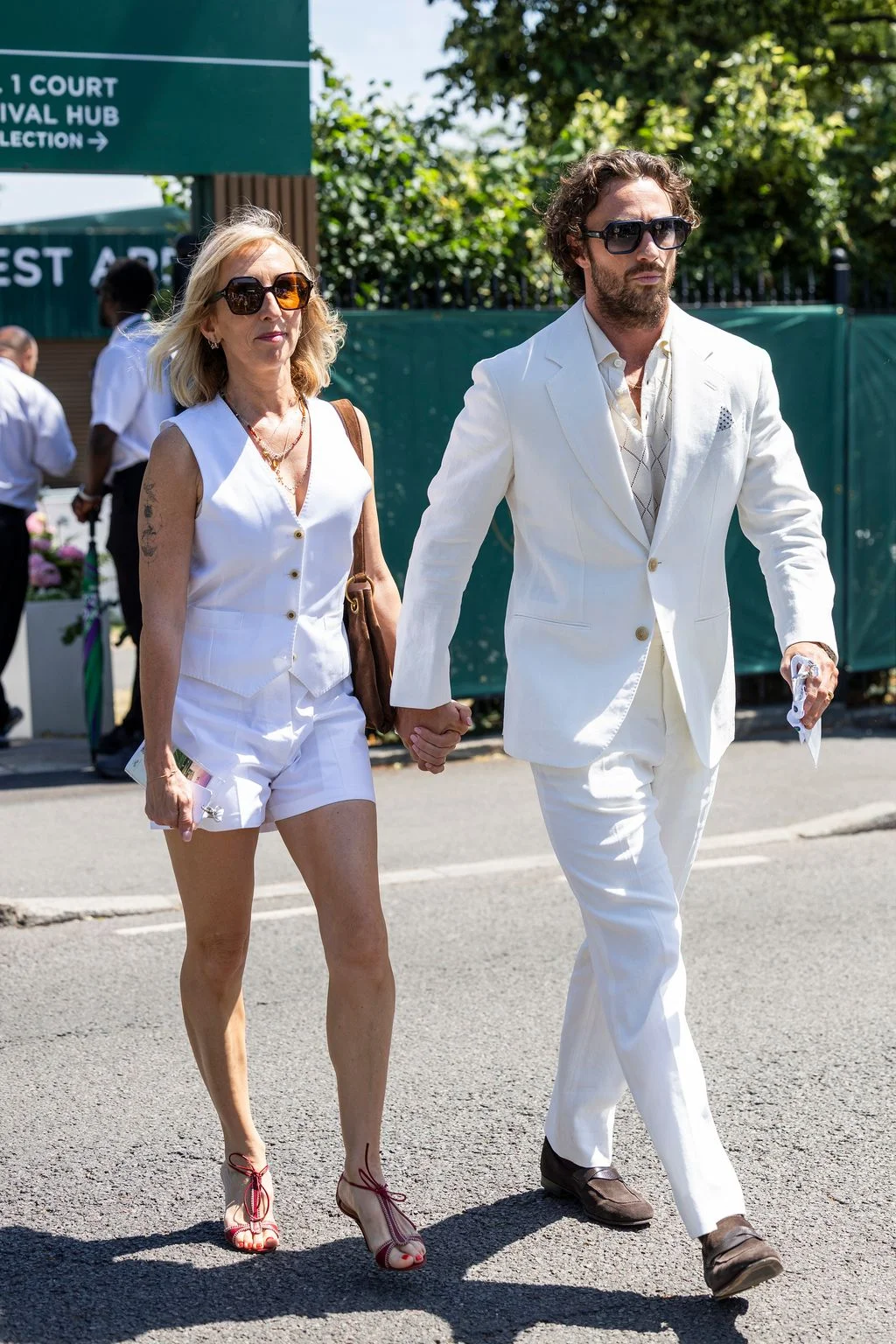 Image may contain Aaron TaylorJohnson Sam TaylorJohnson Body Part Hand Person Holding Hands Adult and Pedestrian