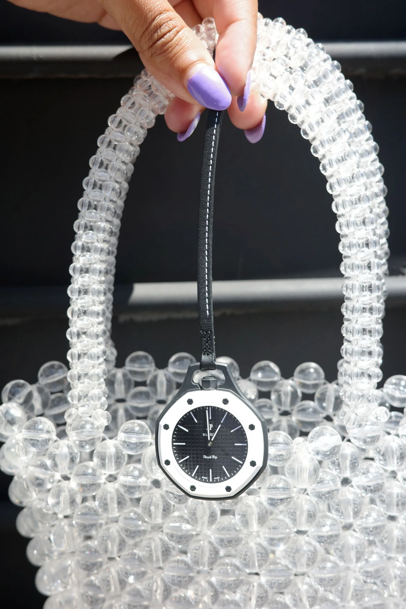 Image may contain Wristwatch Accessories Bag Handbag Body Part Finger Hand Person Jewelry Necklace and Arm