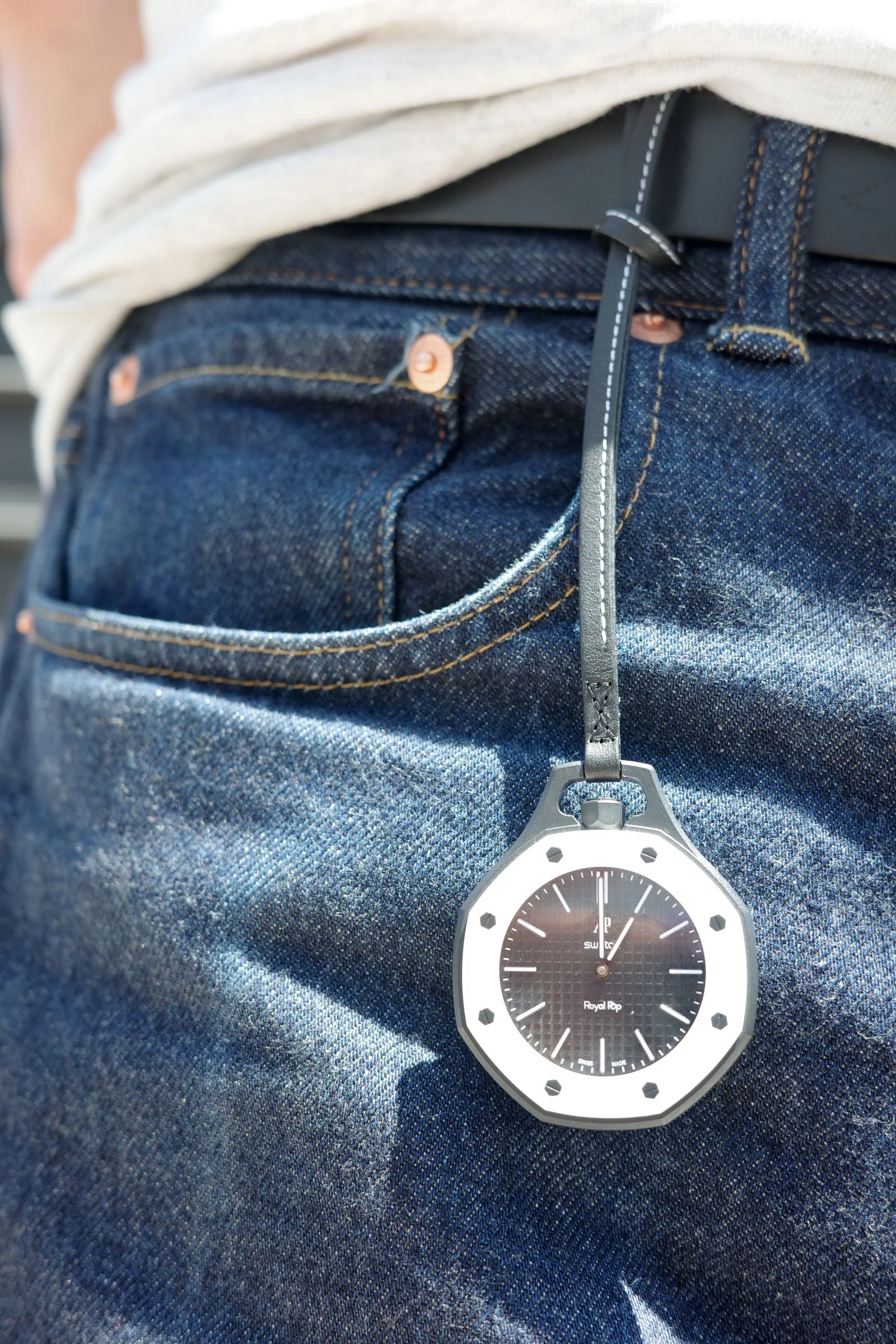Image may contain Wristwatch Clothing Pants Arm Body Part and Person
