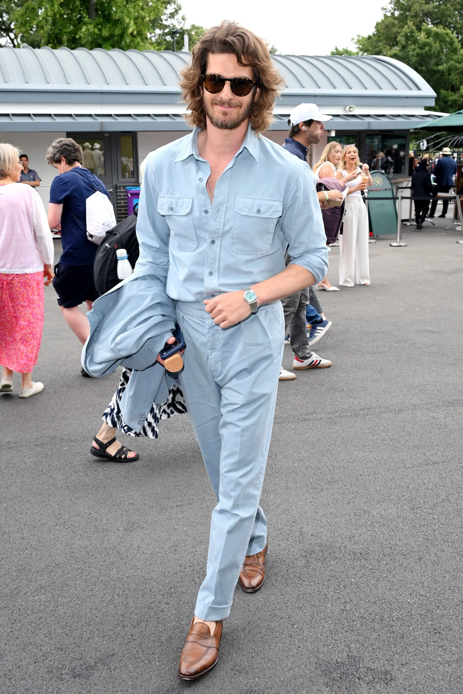 Image may contain Andrew Garfield Adrian Otaegui Elisa Carrió Clothing Pants Adult Person Footwear Sandal and Shoe