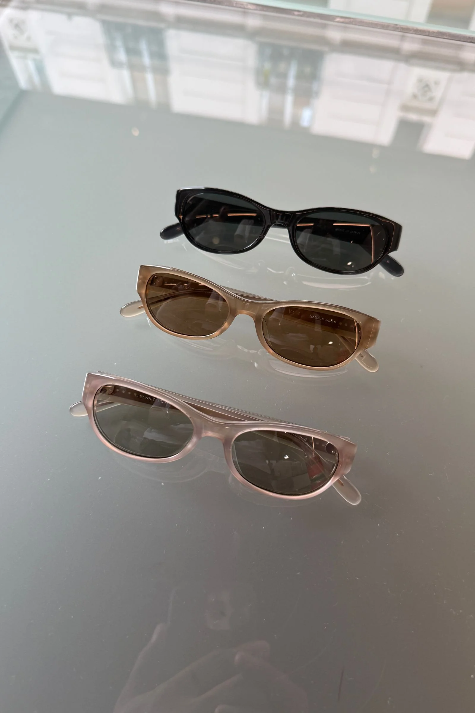 Three sunglasses on a table