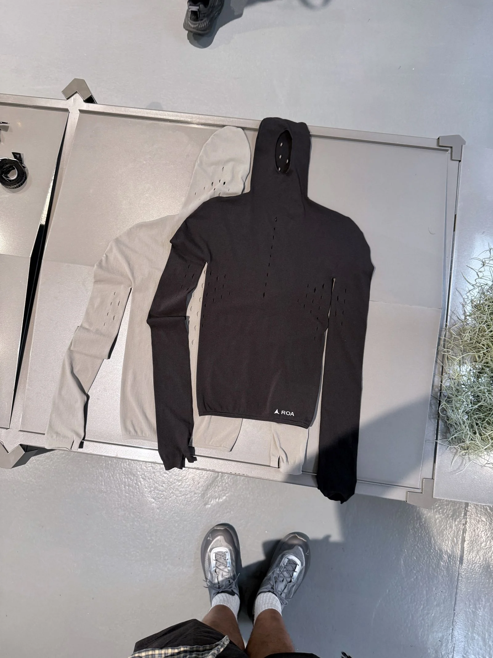 Two flatpacked hoodies one in white and the other in black