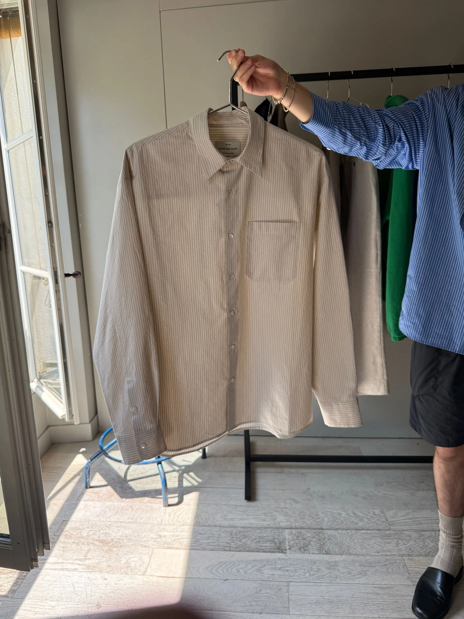 A striped buttonup on a hanger
