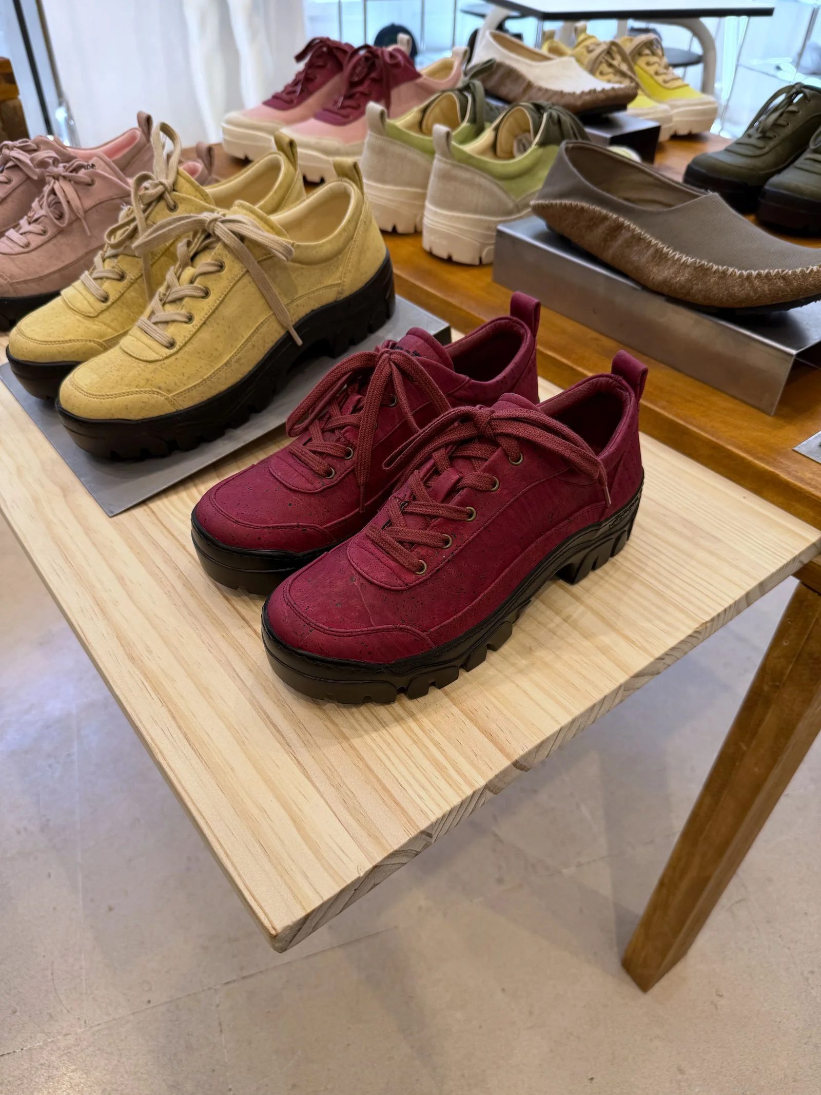 Pairs of colorful shoes on a wooden table