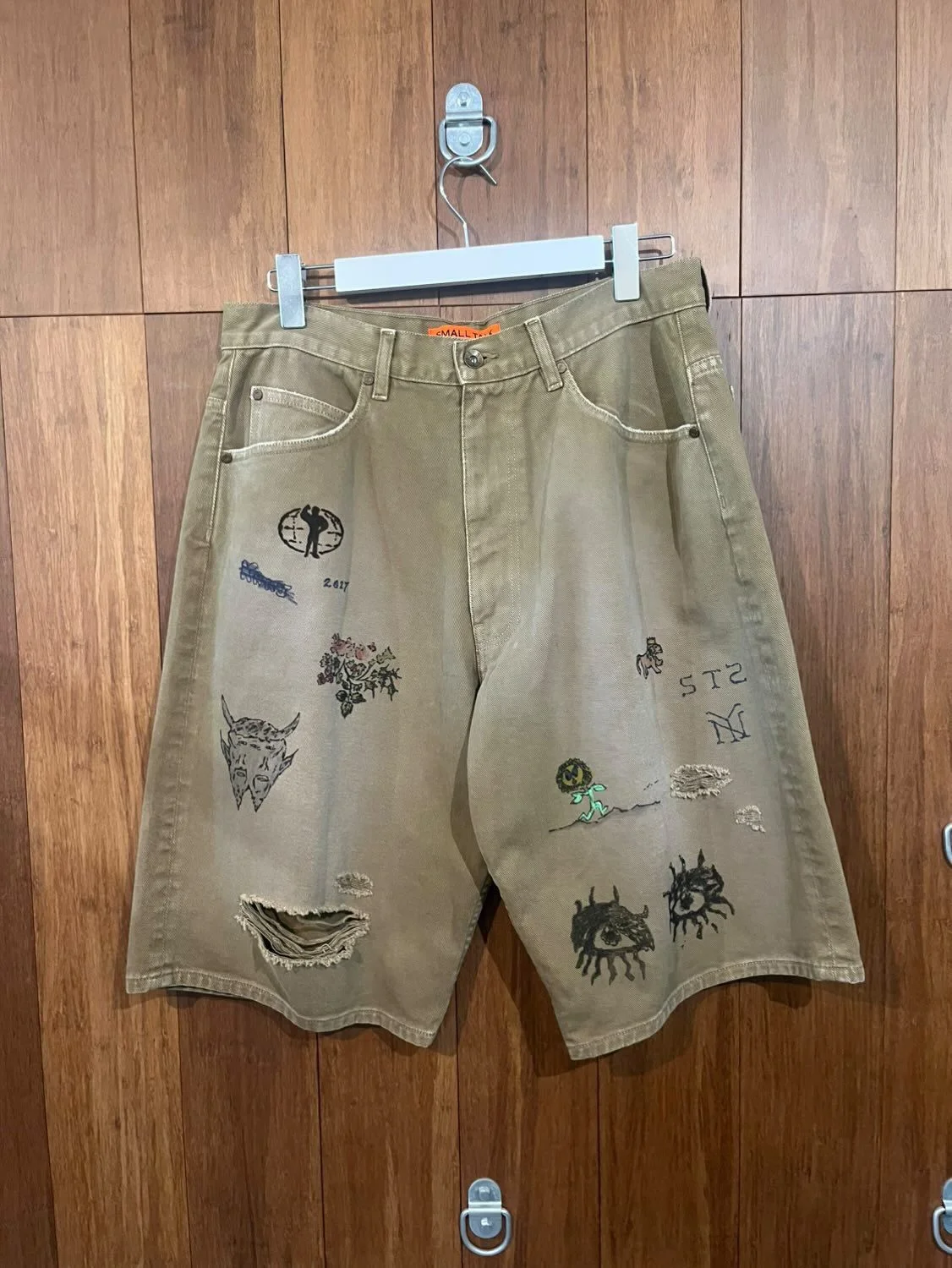 A pair of shorts with illustrations embroidered into the legs