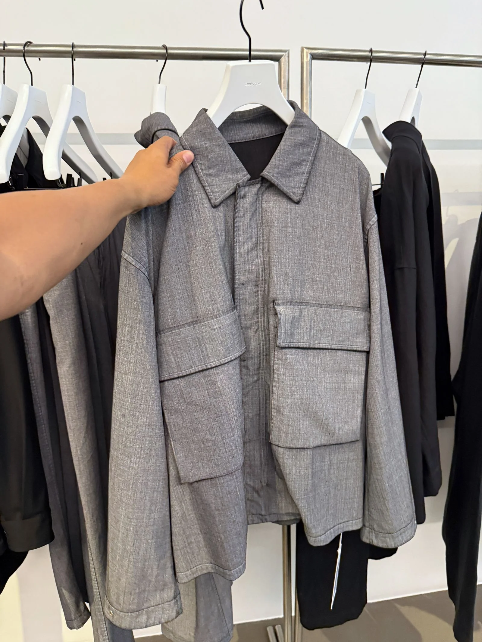 A gray jacket featuring two massive front pockets