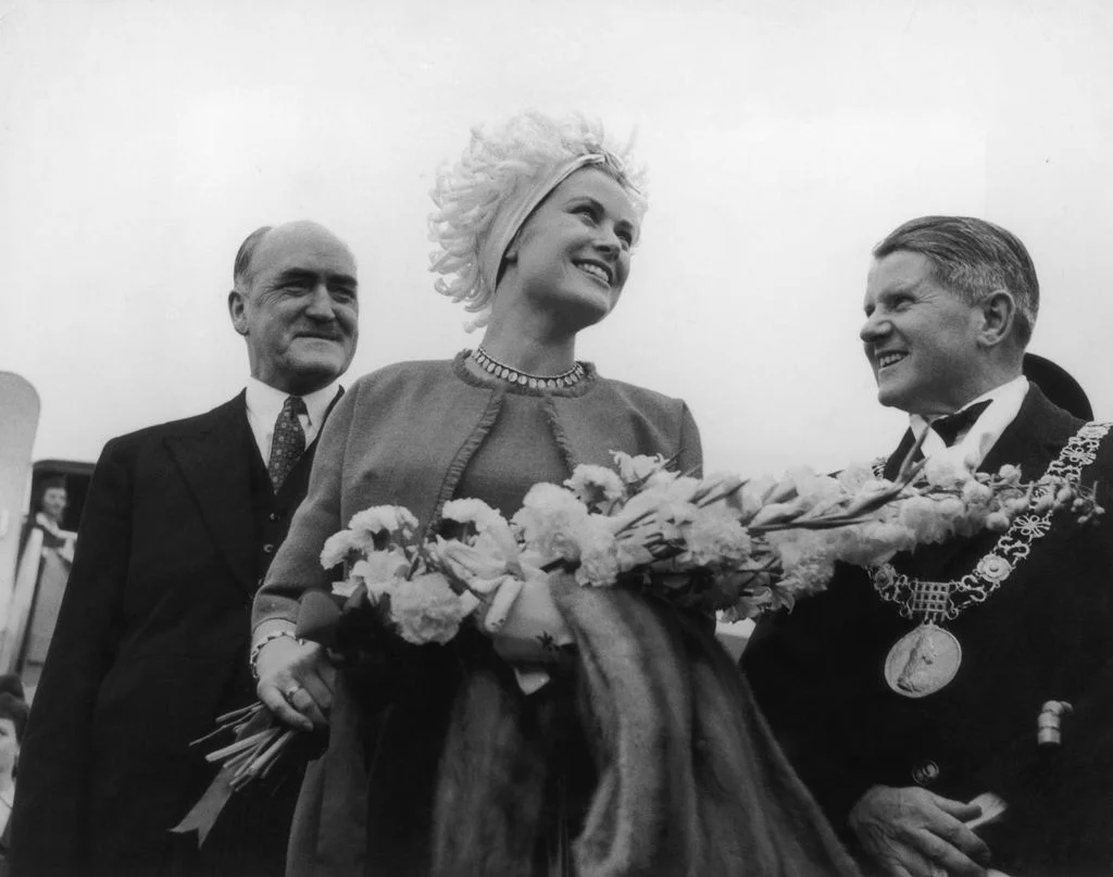 Image may contain Grace Kelly Oswald Pohl Person Adult Wedding Clothing Formal Wear Suit Face Head and Photography