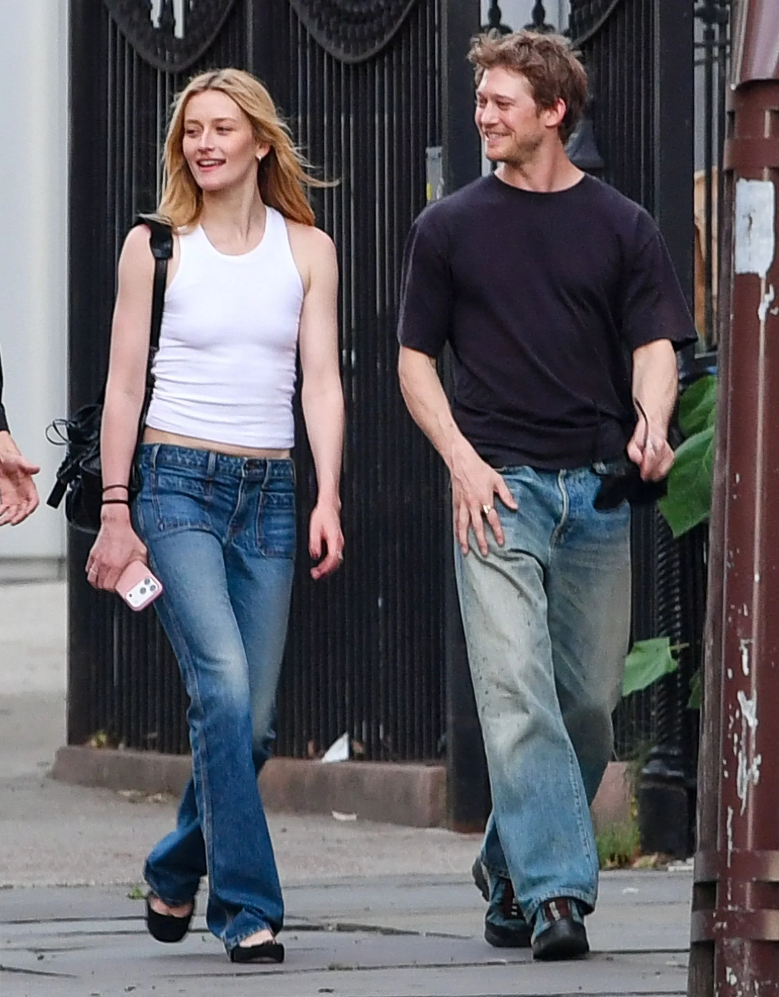 Image may contain Joe Alwyn Clothing Pants Jeans Adult Person Body Part Hand Holding Hands and Teen