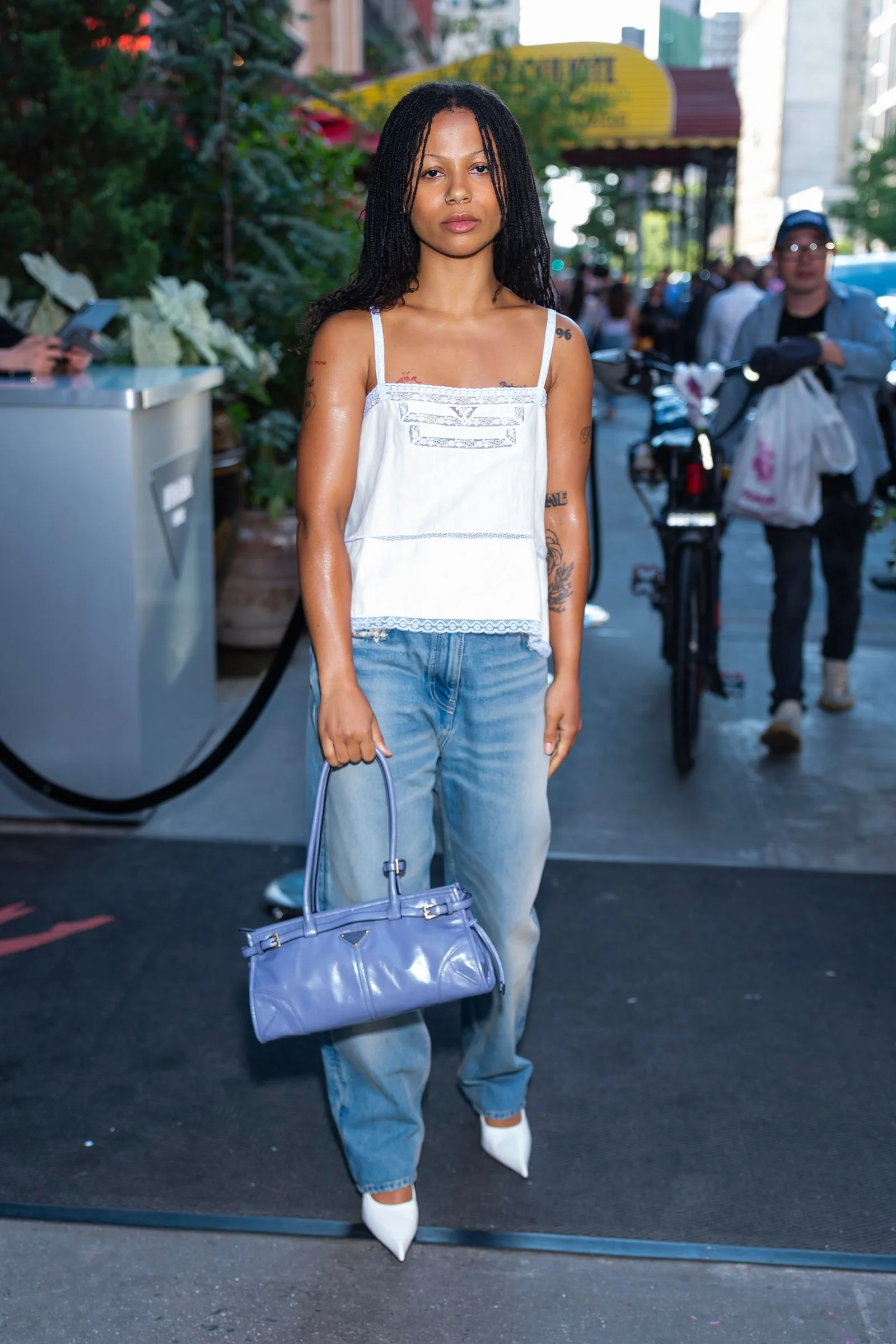 Image may contain Thishiwe Ziqubu Clothing Pants Jeans Accessories Bag Handbag Adult Person Glove and Footwear