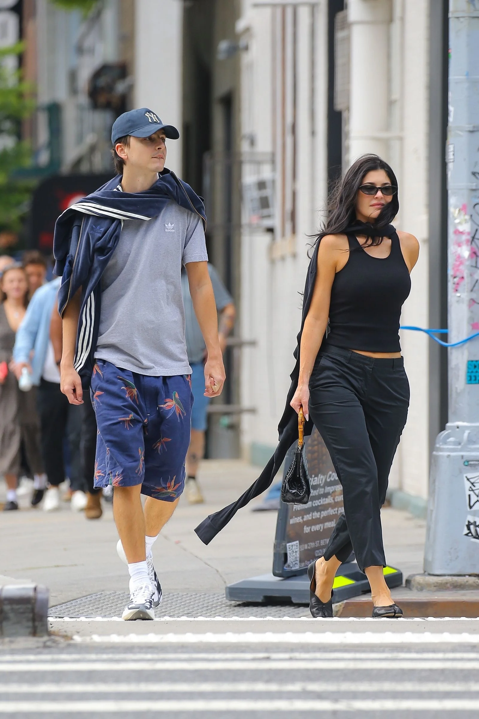 Image may contain Timothe Chalamet Kylie Jenner Pedestrian Person Adult Clothing Shorts Baseball Cap Cap and Hat
