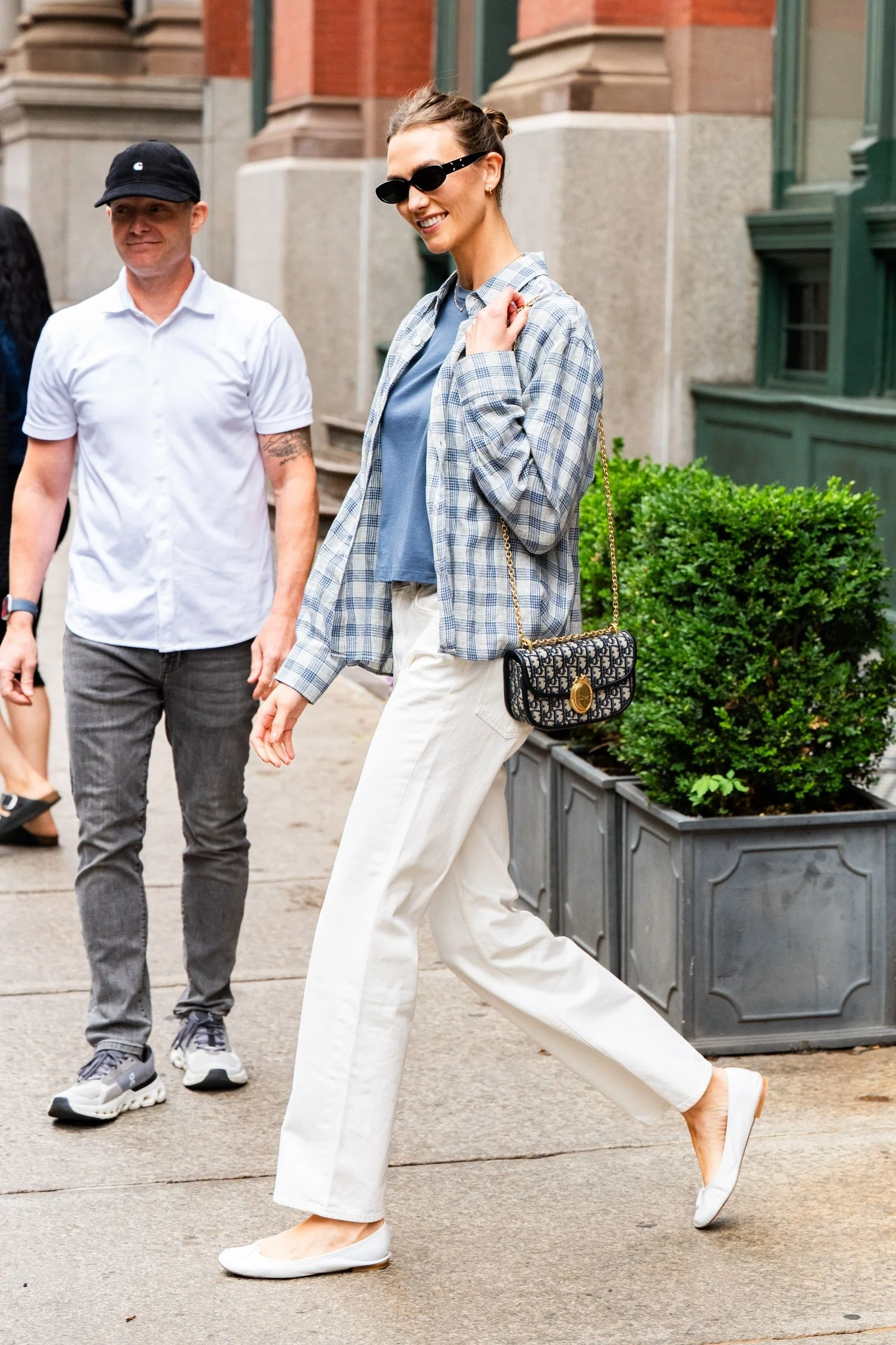 Image may contain Pedestrian Person Clothing Pants Body Part Hand Walking Adult Holding Hands Accessories and Bag