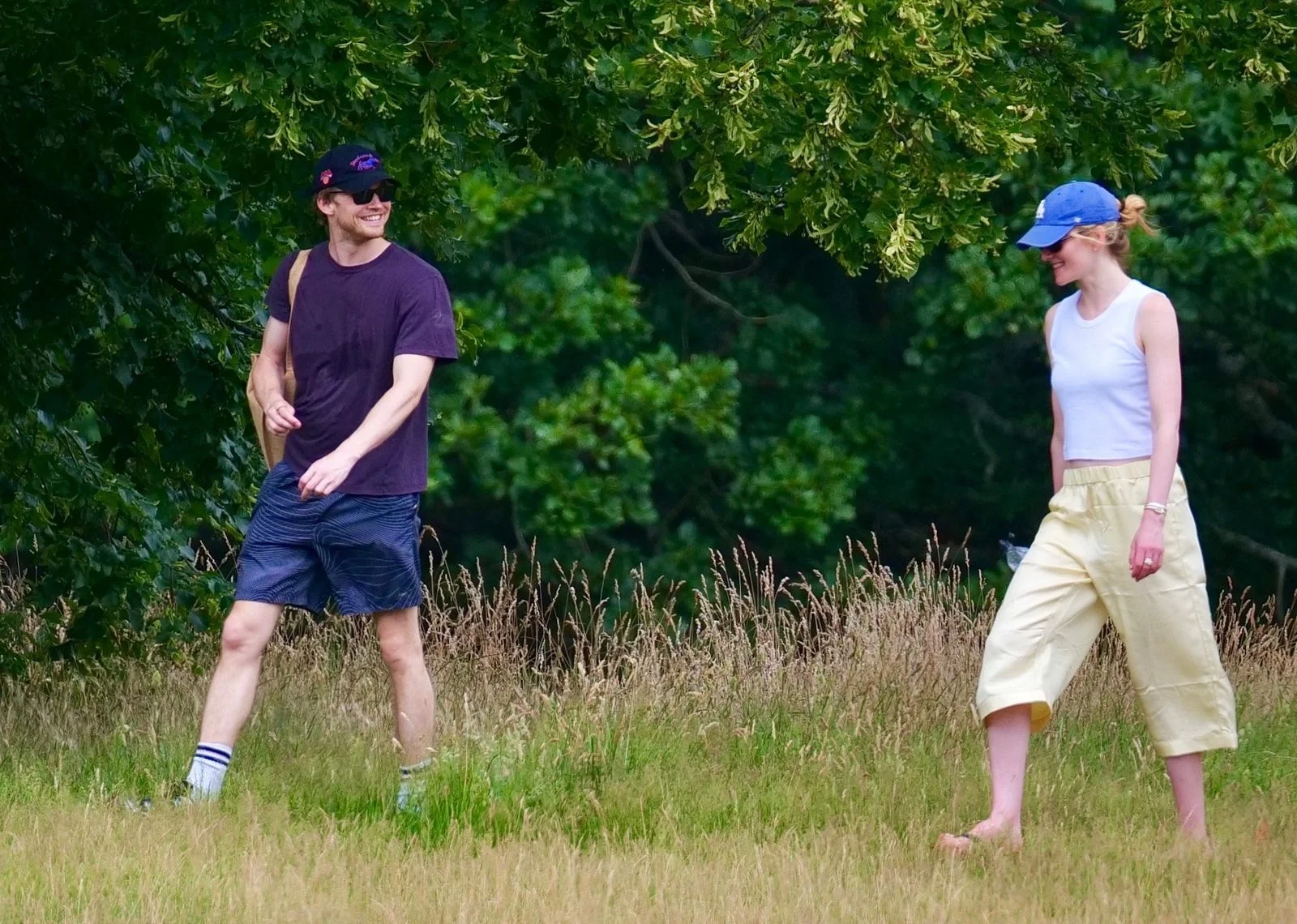 Image may contain Clothing Shorts TShirt Grass Plant Vegetation Adult Person Hat Accessories and Glasses