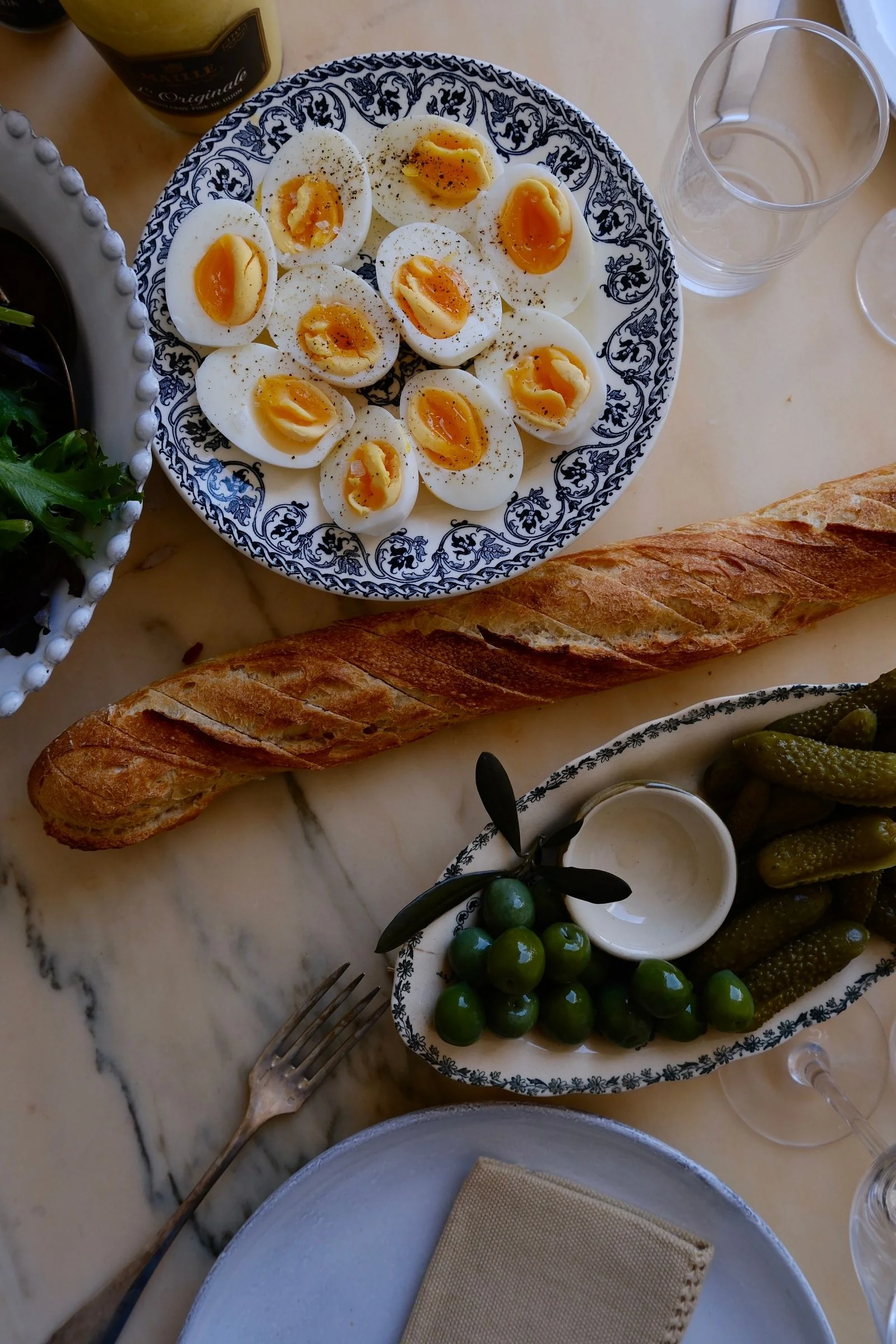 Image may contain Brunch Food Food Presentation Bread Egg Cutlery Fork Baguette Plate and Cup