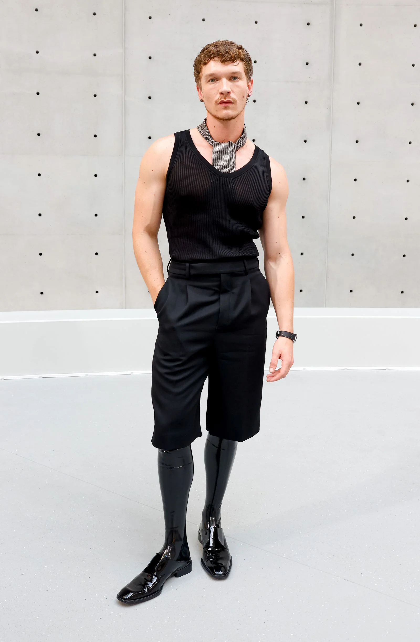 Image may contain Formal Wear Clothing Dress Vest Person Standing Adult Blouse Accessories and Suit