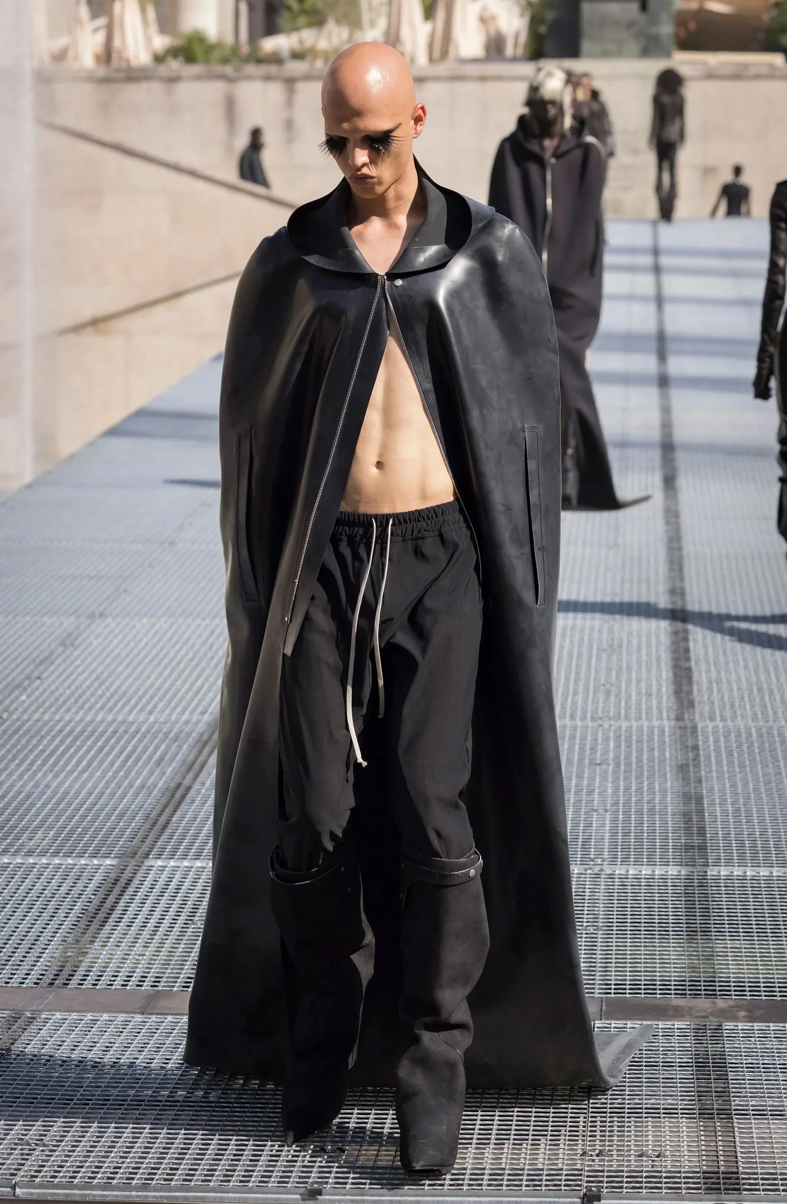 Image may contain Fashion Clothing Coat Adult Person Cape and Cloak