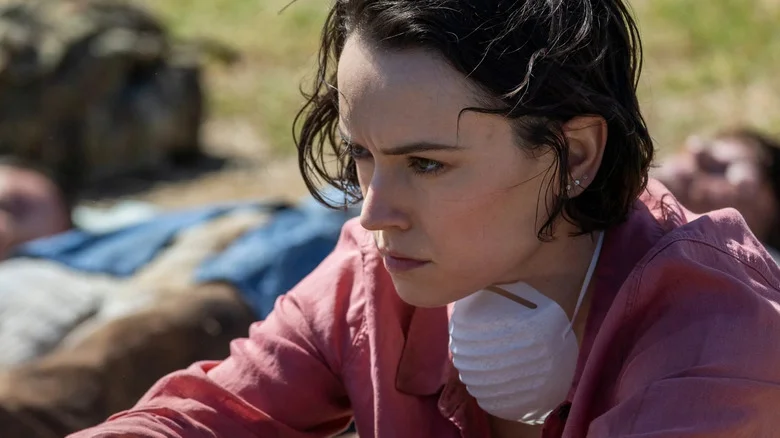 Daisy Ridley as Ava Newman contemplating her new reality while surrounded by zombies in We Bury the Dead