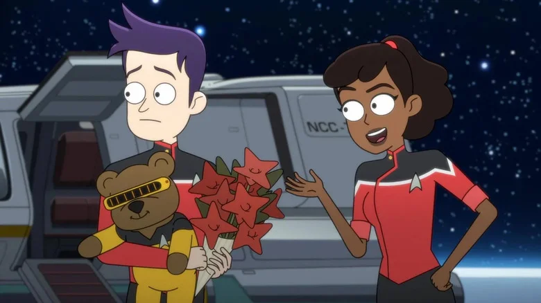 Brad Boimler (Jack Quaid) holds a bunch of collectibles next to Beckett Mariner (Tawny Newsome) in Star Trek: Lower Decks