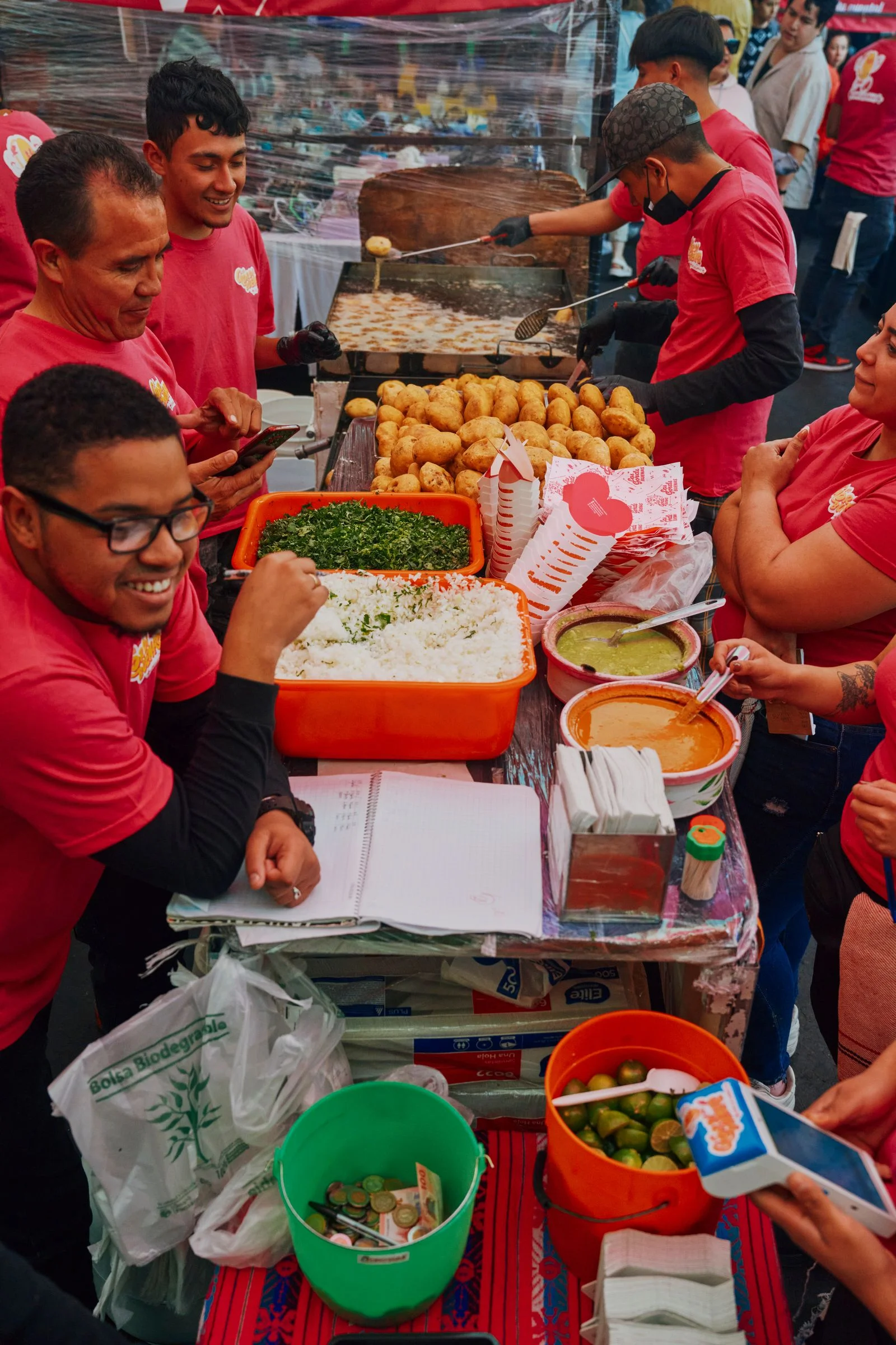 Image may contain Adult Person Teen Team Clothing Glove Food Gorditas Fritters Face and Head